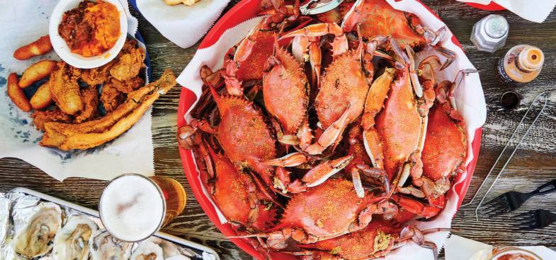 Rustic coastal crab shack seafood spread with crab clusters and oysters