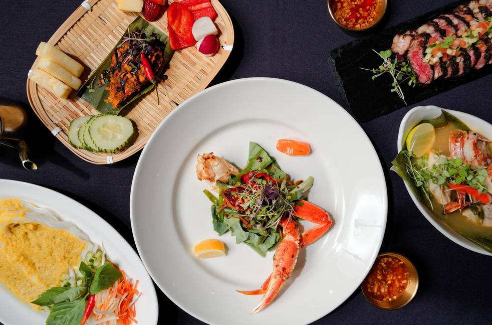 Fine dining crab tasting spread as a restaurant hero backdrop