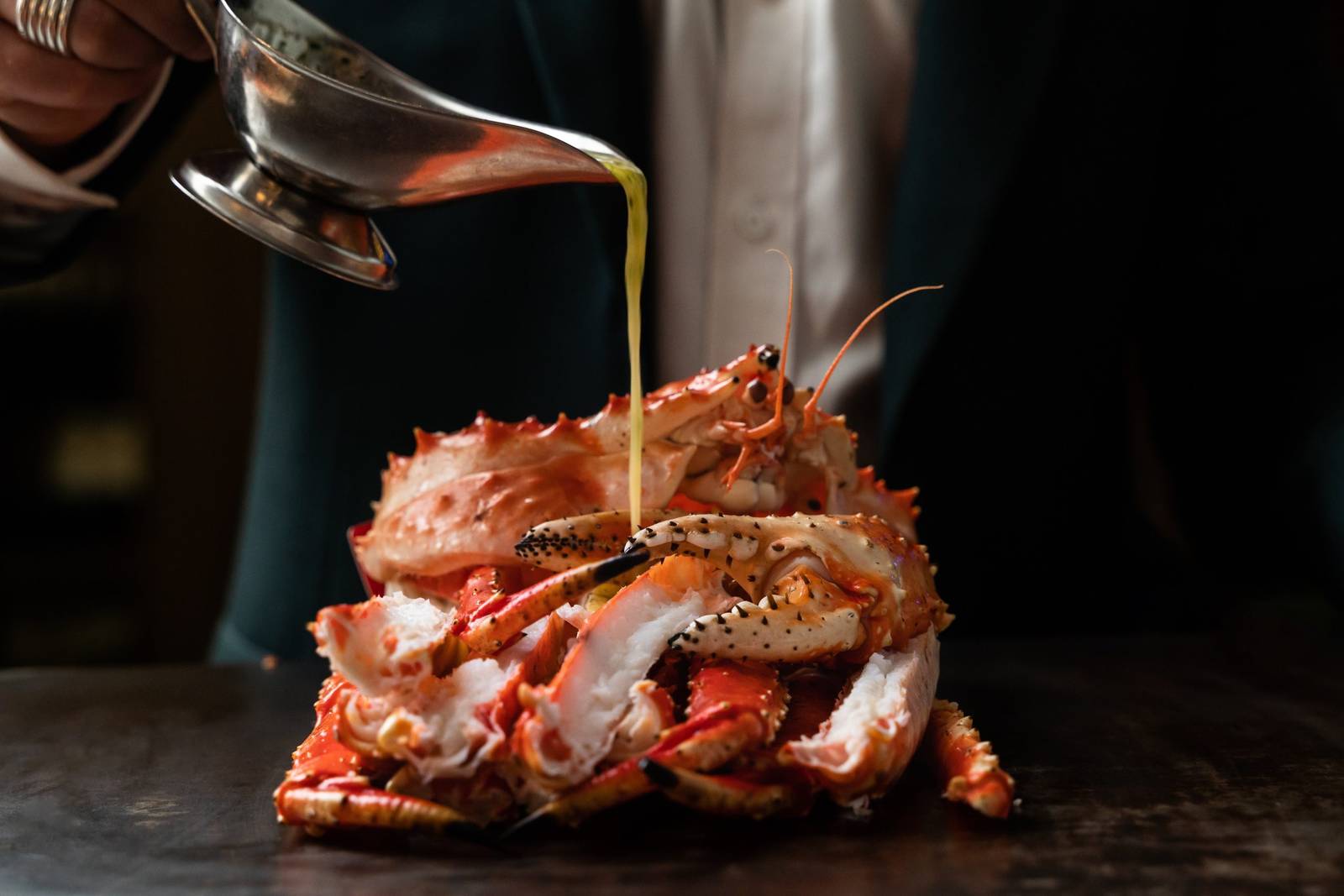 Garlic butter sauce poured over a whole steamed crab