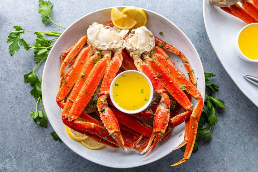 Golden curry crab on a white platter with a carved vegetable garnish