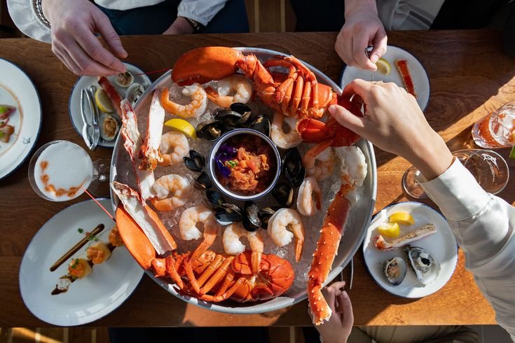 Overhead seafood boil platter shared across a restaurant table